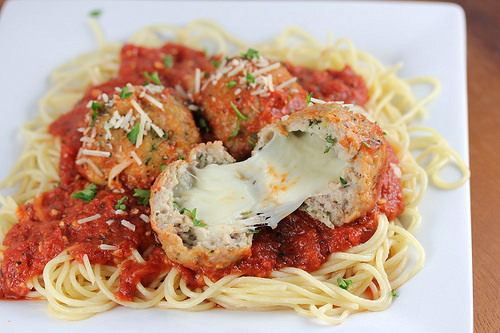 Turkey meatballs stuffed with melted mozzarella served over spaghetti with marinara sauce and shredded parmesan