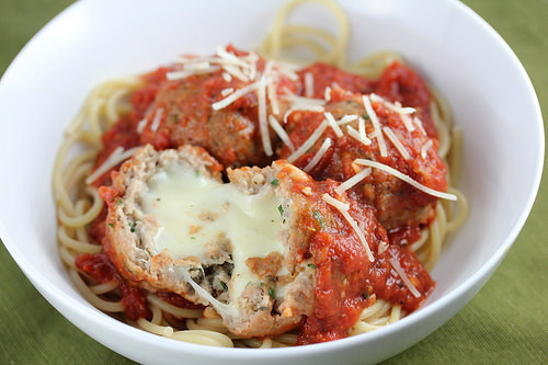 Turkey meatballs stuffed with melted mozzarella served over spaghetti with marinara sauce and shredded parmesan