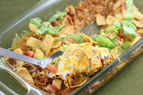 Frito taco casserole, with serving spoon