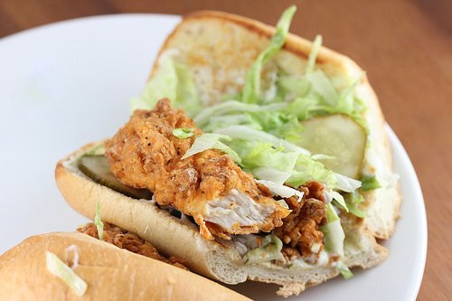 Popeyes-style shrimp po’ boy loaded with fried shrimp, pickles, and lettuce on bread