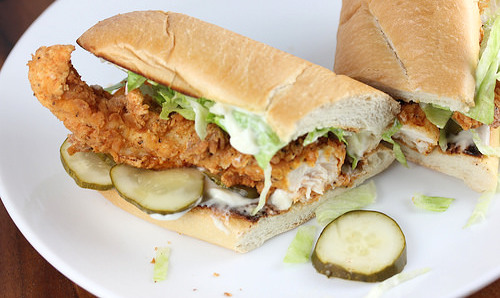 Popeyes-style shrimp po’ boy loaded with fried shrimp, pickles, and lettuce on bread