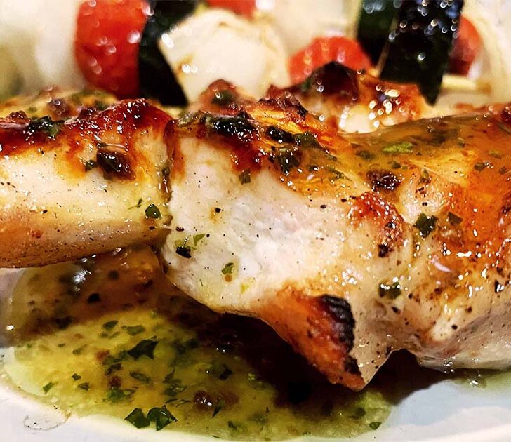 Grilled chicken skewers with roasted garlic vinaigrette.