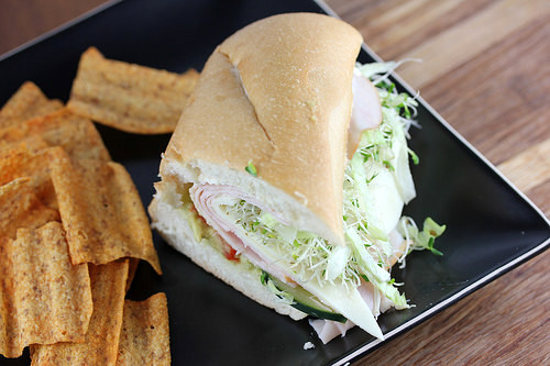 Beach club sandwich with turkey avocado sprouts and fresh vegetables on sub roll