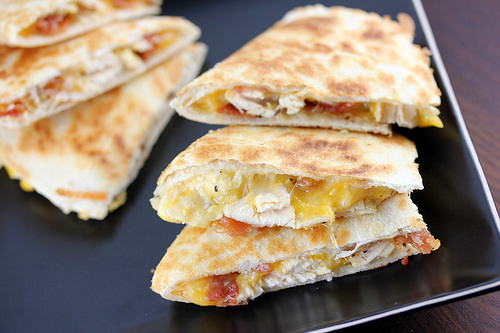 Chicken bacon ranch quesadilla slices on a black plate