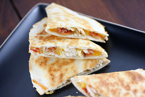 Chicken bacon ranch quesadilla slices on a black plate