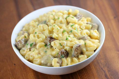 Bowl of steak mac and cheese topped with parsley
