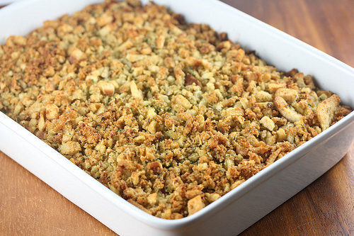 Baked chicken and rice casserole in a white dish with stuffed topping