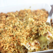 Baked chicken and rice casserole in a white dish with stuffed topping