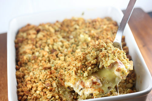 Baked chicken and rice casserole in a white dish with stuffed topping