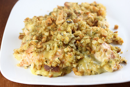 Baked chicken and rice casserole in a white dish with stuffed topping