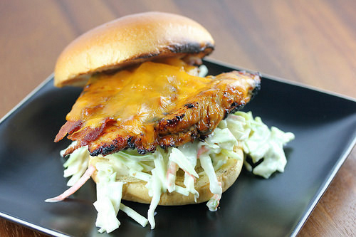 Grilled chicken sandwich with melted cheddar and creamy coleslaw on a bun