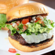 Pico guacamole burger with lettuce tomato and melted cheese on a toasted bun
