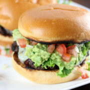 Pico guacamole burger with lettuce tomato and melted cheese on a toasted bun
