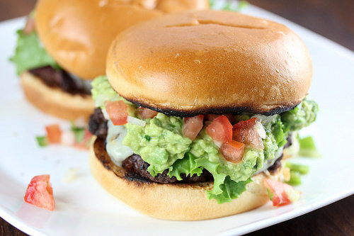 Pico guacamole burger with lettuce tomato and melted cheese on a toasted bun