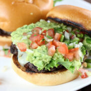 Pico guacamole burger with lettuce tomato and melted cheese on a toasted bun