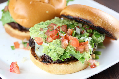 Pico guacamole burger with lettuce tomato and melted cheese on a toasted bun