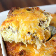 Cheesy sausage and hash brown casserole baked in a white dish