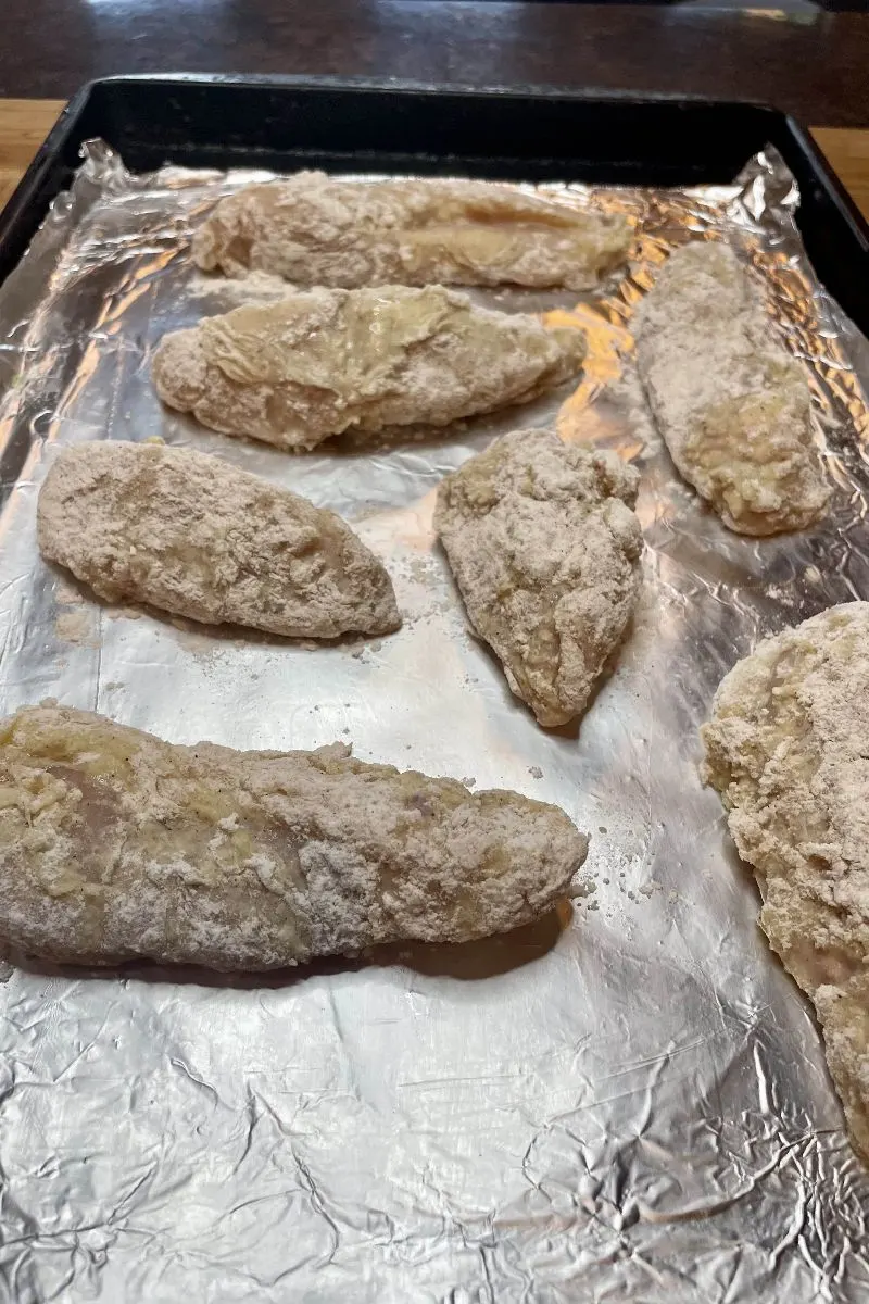 Breaded chicken pieces, ready for frying.