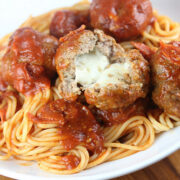 Plate of spaghetti with meatballs covered in marinara sauce