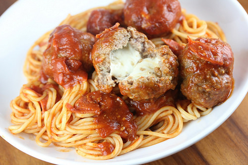 Plate of spaghetti with meatballs covered in marinara sauce