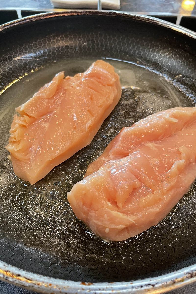 Chicken breasts cooking for Doritos chicken nachos.