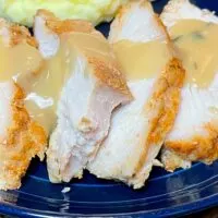 Slow cooker turkey breast, prepared and sliced with gravy.