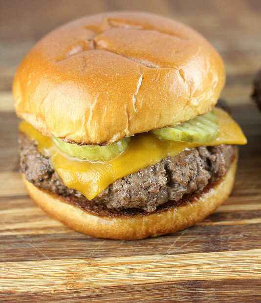 Culvers butter burger with cheddar cheese and pickles on a toasted bun