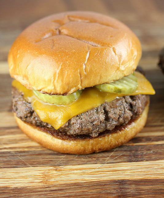 Culvers butter burger with cheddar cheese and pickles on a toasted bun