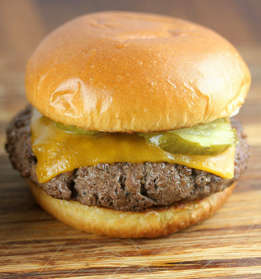 Culvers butter burger with cheddar cheese and pickles on a toasted bun