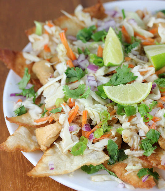 Wonton chicken nachos topped with lime and cilantro