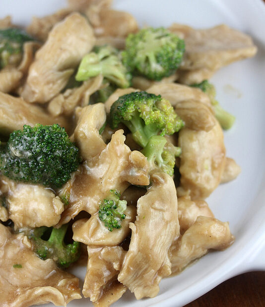 Chinese buffet broccoli chicken with savory sauce served in a white bowl