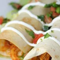 Close up view of baked chicken taquitos.