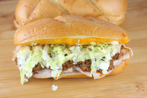 Turkey taco grinder sandwich with lettuce and cheese.