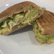 Coronation chicken salad sandwich cut in half and served on a white plate