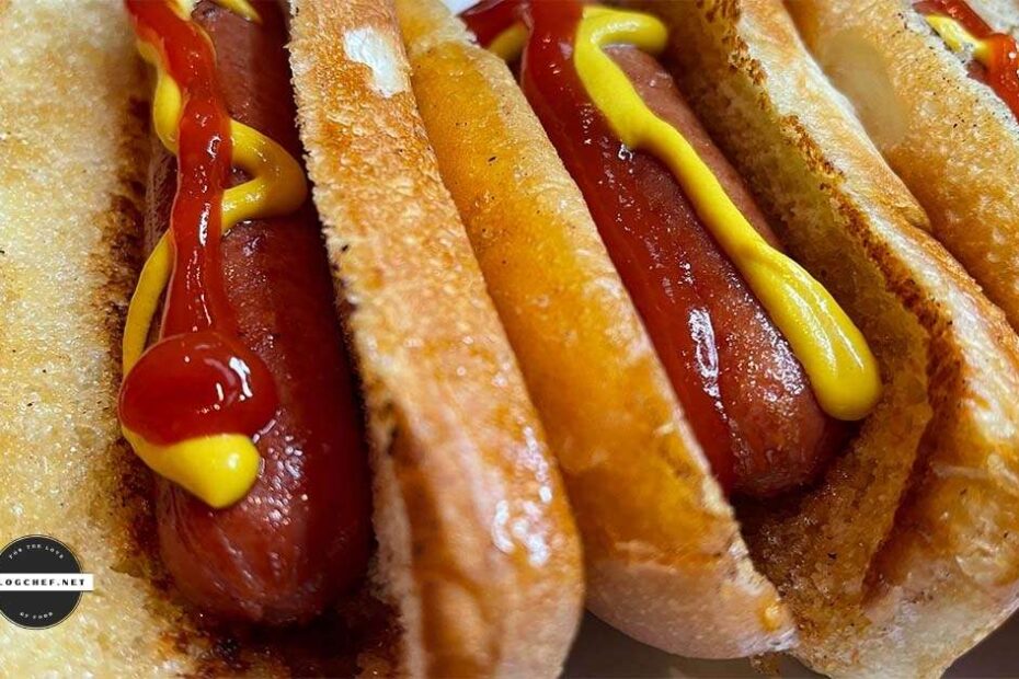 Stovetop hotdogs in buns with ketchup and mustard.