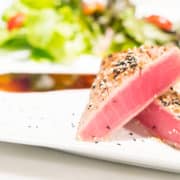 Oven-baked tuna steaks served over green beans and tomatoes