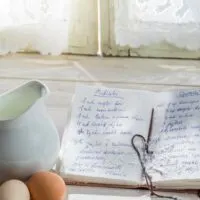 Cookbook propped up on cookbook holder in kitchen.