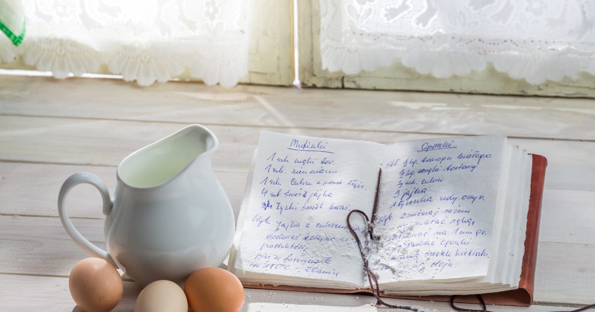 Cookbook propped up on cookbook holder in kitchen.