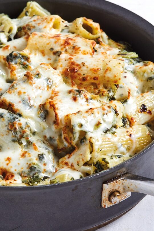 Close up of artichoke spinach dip pasta in pot.