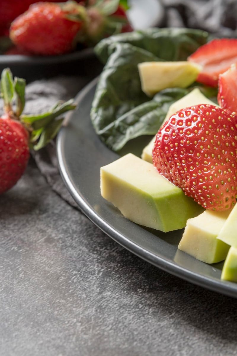 Top view of spinach and strawberry salad.