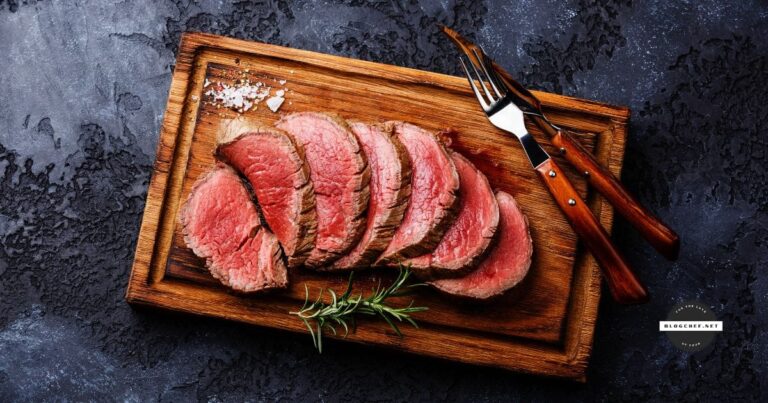 Sliced steak on cutting board