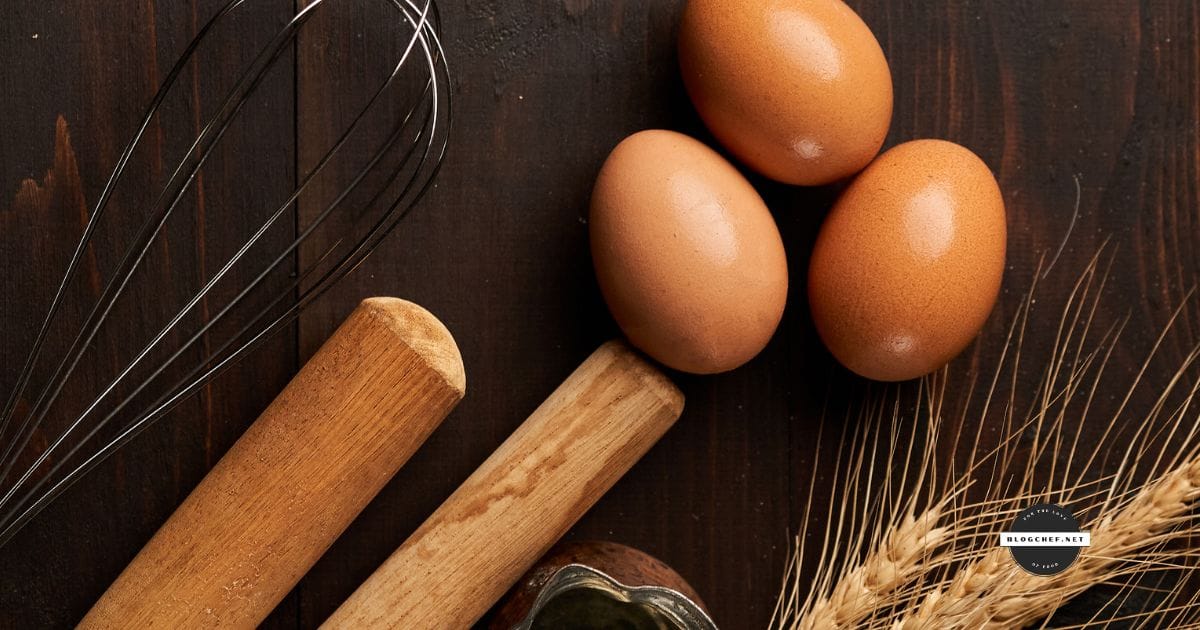 Eggs and wheat on dark surface.