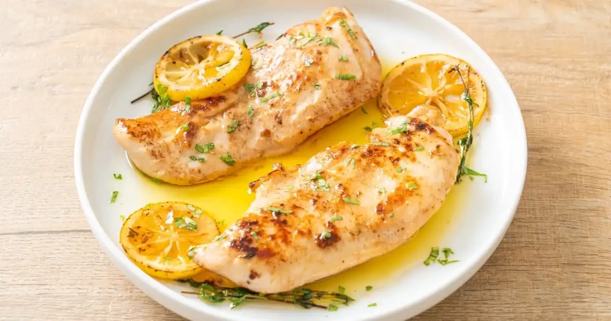 Top view of thin cooked chicken breast on plate.