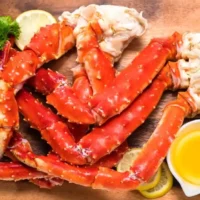 Cooked crab legs with melted butter.