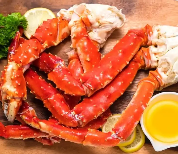 Cooked crab legs with melted butter.