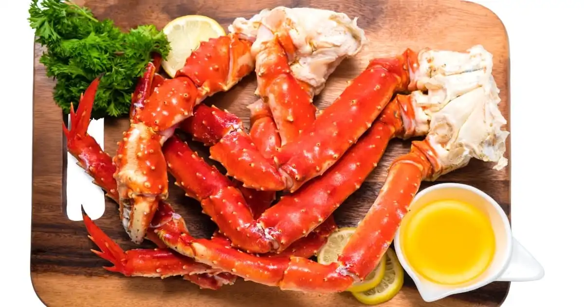 Cooked crab legs with melted butter.