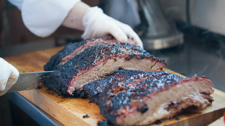 Prepared, sliced brisket on cutting board.