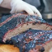 Prepared, sliced brisket on cutting board.