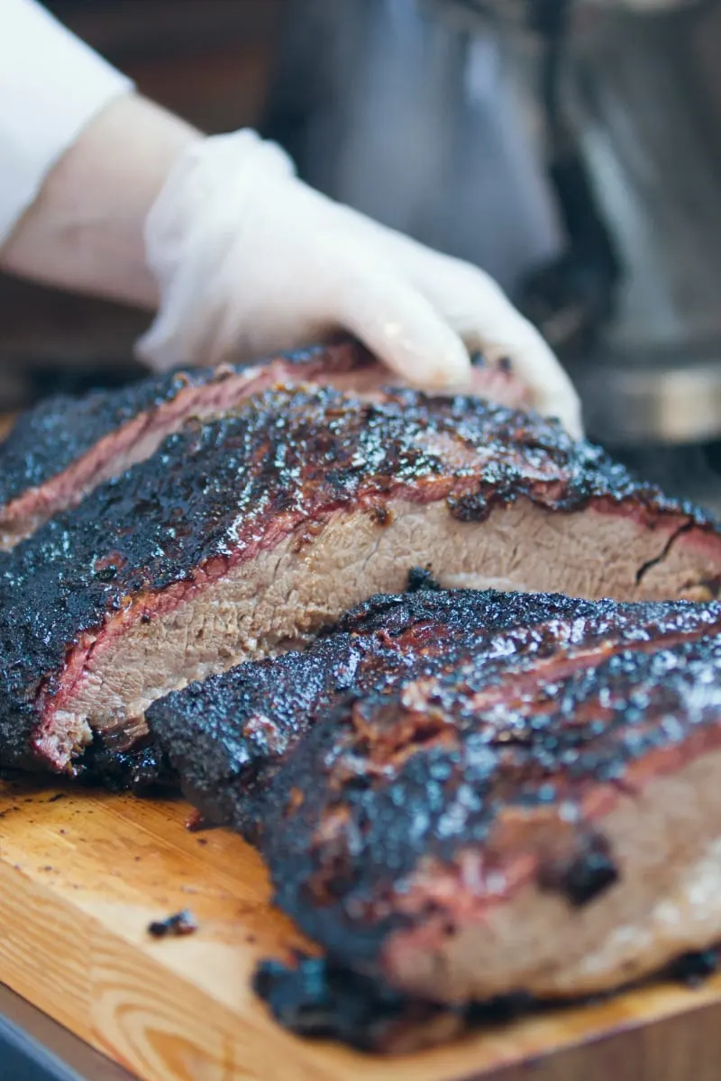 Prepared, sliced brisket on cutting board.