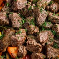 Cubed cooked rump roast in pot with vegetables.